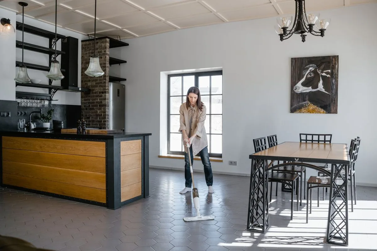 A cleaner mopping a floor